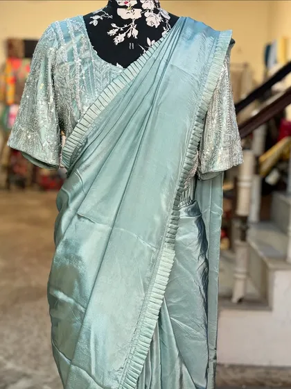 The 'MANOHARI' saree without its jacket, showcasing the beautifully crafted blouse with flared sleeves and the simple, elegant drape of the saree.