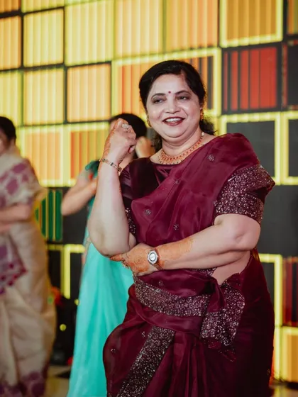 Capturing happy moments at a Sangeet event. The backdrop features a modern, backlit geometric pattern that created a warm and stylish ambiance for the celebration.