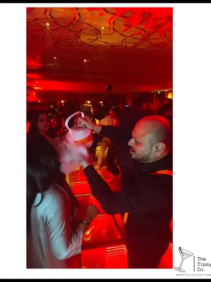 A smoky, theatrical drink being served from a kettle. This is an example of our molecular mixology techniques, where we use dry ice to create a dramatic smoky effect that captivates guests.