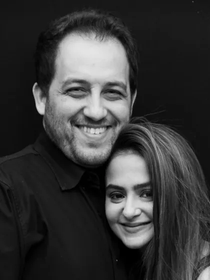 A black and white portrait can bring out the raw emotion and connection in a photograph. The genuine, happy smiles on this couple's faces tell a story of shared joy and deep affection.