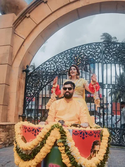 Making an entrance in style! The couple arrives for their Haldi ceremony on a decorated scooter, a fun and quirky touch that reflects their personality.