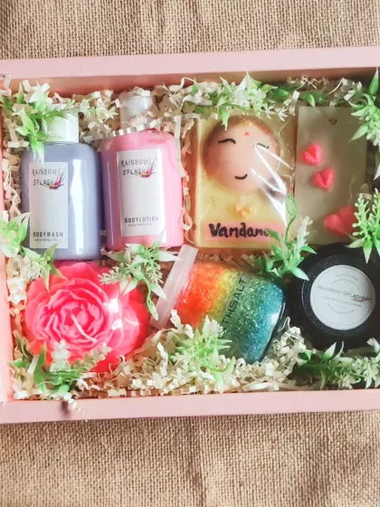 Another look inside the bridesmaid hamper, showing the personalized "Vandana" soap, rainbow bath salts, and other pampering items.