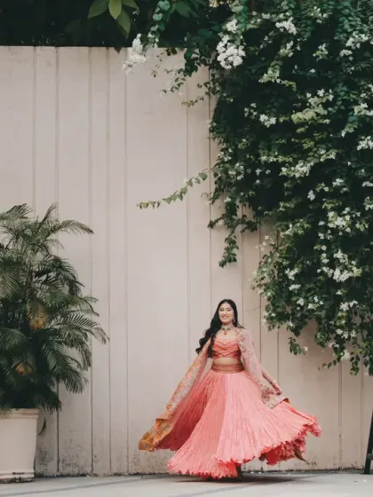 The perfect bridal twirl. Akriti looks like poetry in motion in her beautiful pink lehenga. This is a classic shot that every bride dreams of, full of grace, joy, and movement.