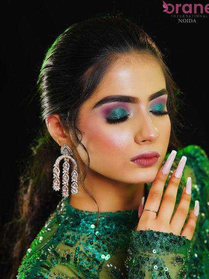 A close-up of the stunning green and purple eye makeup, complemented by the soft hairstyle.