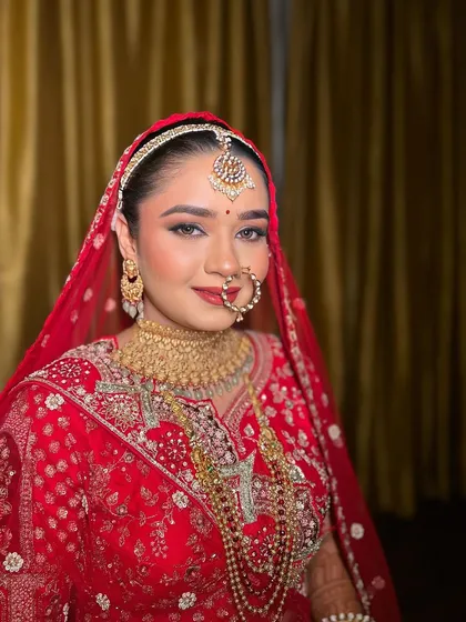 A beautiful portrait of my classic bride. The gold jewelry and red lehenga are perfectly complemented by the warm, glowing makeup.