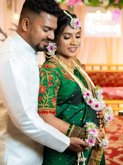 A beautiful moment between the happy couple at their baby shower, with the mom-to-be's intricate mehendi adding to her glow.