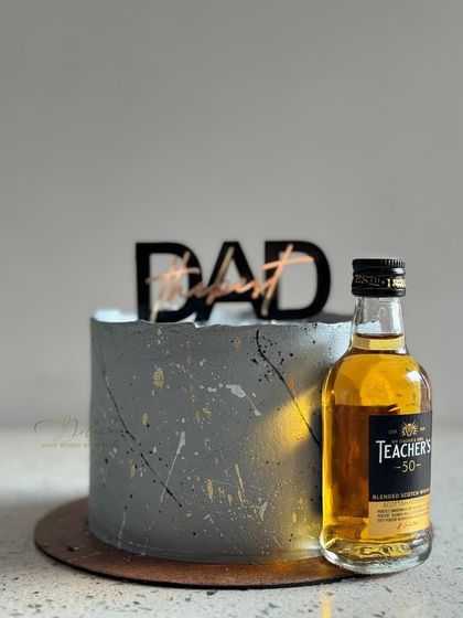 This modern grey miniature cake is another popular choice for Father's Day. It has a cool, textured finish with gold and black splatters, and I can pair it with a miniature bottle of your dad's favorite drink.