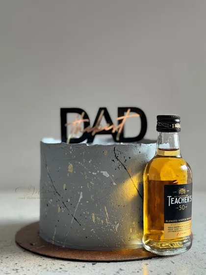 A sophisticated grey miniature cake for Father's Day, perfect for pairing with his favorite miniature bottle of whiskey.