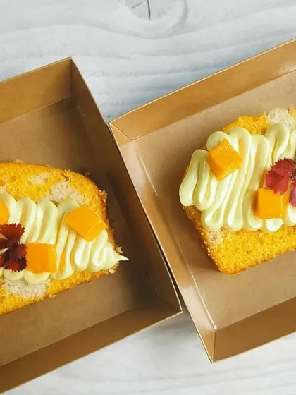 For parties and bulk orders, I offer individual cake slices. Here are two of my popular flavors: the tropical Coconut Mango and the rich Choco Pistachio marble cake slices.