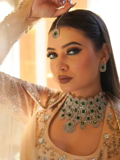 A bold and dramatic look from my Riwayat collection. I created this sharp, emerald green winged eyeliner and paired it with a matte nude lip to complement the stunning traditional jewelry, perfect for a sangeet or wedding guest.