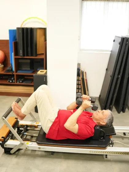 Mr. Harsh Kumar performs a chest press on the reformer. This exercise strengthens his upper body while the machine supports his back, making it a safe and effective way for him to build muscle and improve function.