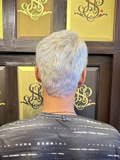 Men's hair colour can be a game-changer. This client went for a full platinum blonde transformation, a bold and stylish look that requires professional expertise to achieve correctly.