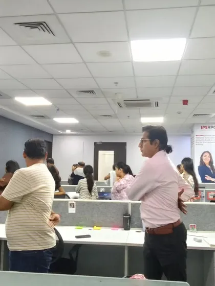 Employees participate in a standing stretch during our corporate yoga session. These simple movements help to counteract the negative effects of prolonged sitting by improving circulation and releasing muscle stiffness.