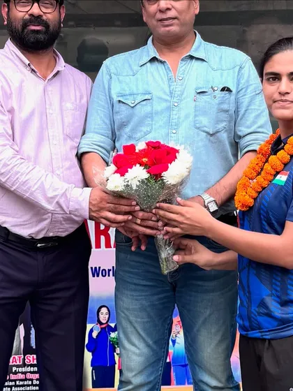 Presenting flowers as a token of good luck to a team member before her departure for the international competition.