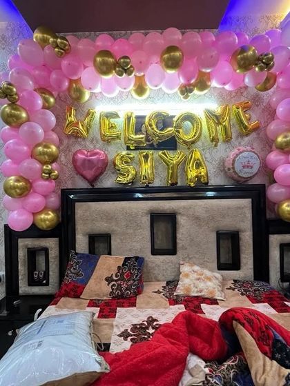 A lovely way to welcome baby Siya home by decorating the master bedroom. I created a dense arch of pink and gold balloons over the headboard with foil letters spelling out her name.