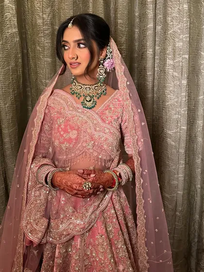 Blending tradition with a touch of modernity. This beautiful bride in a pink lehenga has a soft, defined eye and radiant skin, perfect for her Phera ceremony.