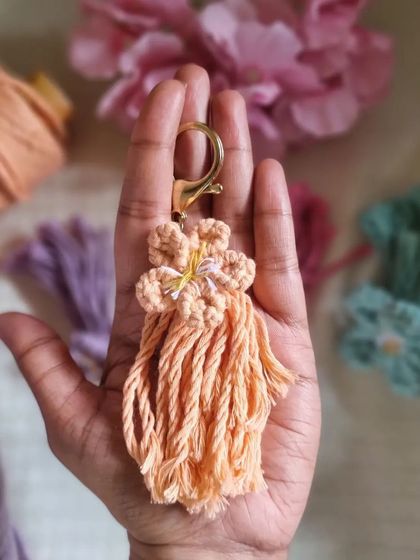 We're so excited to introduce these macrame flower keychains. Held in the palm of a hand, you can see the delicate craftsmanship that makes each one so special.