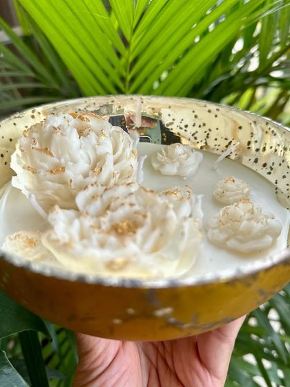 Holding the peony bowl candle to show its size and the beautiful antique finish of the glass bowl.