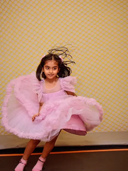 A princess twirling with joy on the trampoline. The perfect action shot!