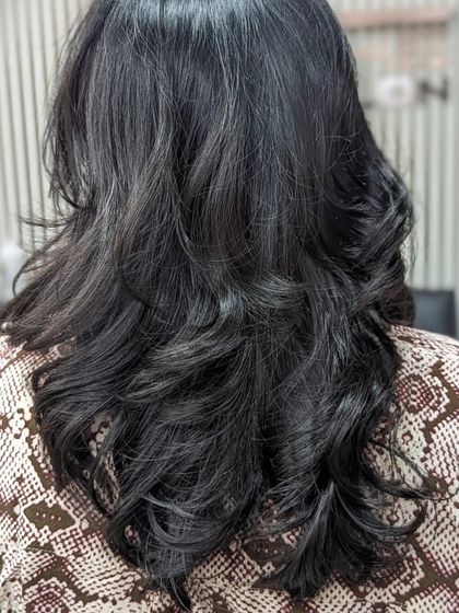 A gorgeous final look with soft, flowing waves. Book an appointment to get your hair looking this healthy and styled.