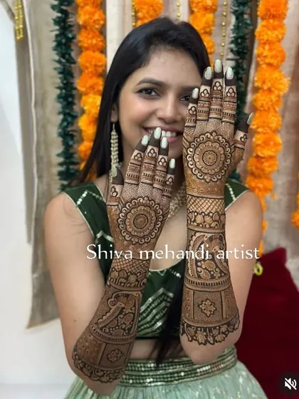 An elegant design featuring a central mandala on the palms. The forearms are adorned with graceful swan motifs and other traditional patterns.
