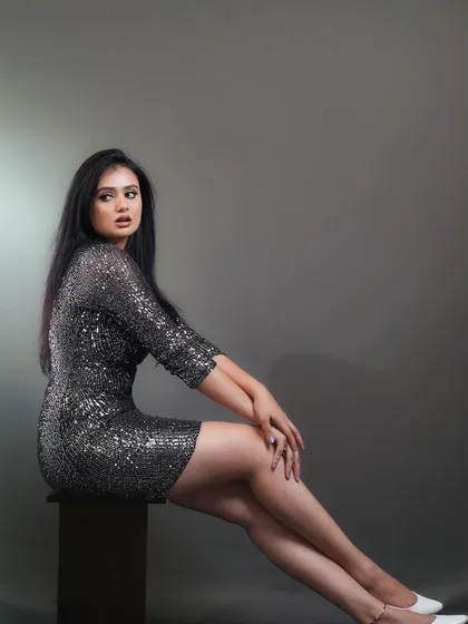 A sleek and modern studio fashion shoot featuring a model in a silver sequin dress. I used controlled lighting to emphasize the texture of the fabric and create a glamorous, high-fashion mood.