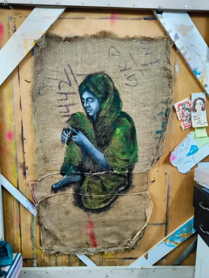The materials I use are part of the story. This piece, "Mending," is painted with acrylics on a repurposed jute bag. For me, the act of mending the rough, humble fabric is a metaphor for mending our world with compassion. It’s about finding beauty and meaning in unexpected places.