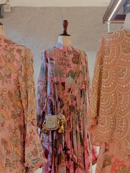 A trio of pink printed and embroidered outfits, showcasing a variety of textures and embellishments.
