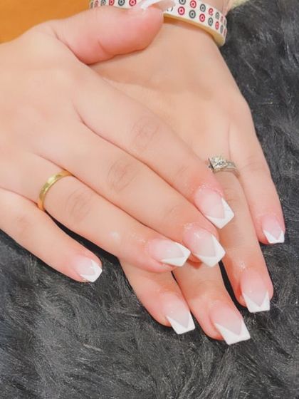 A modern V-shaped French tip design on square nails. The sharp lines give this classic look a contemporary edge.