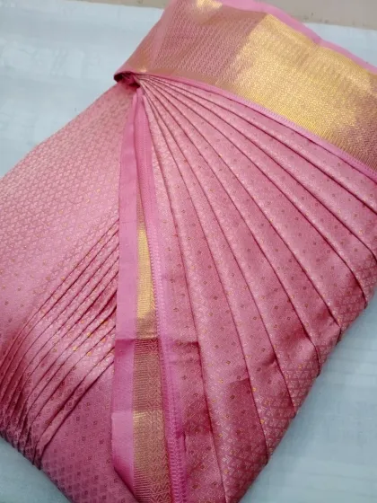 This soft pink silk saree is ready to be draped in less than five minutes, thanks to my pleating service.