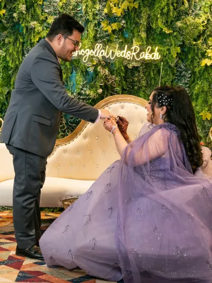 A candid shot of the ring exchange, capturing the bride's happy expression as the groom slips the ring on her finger.