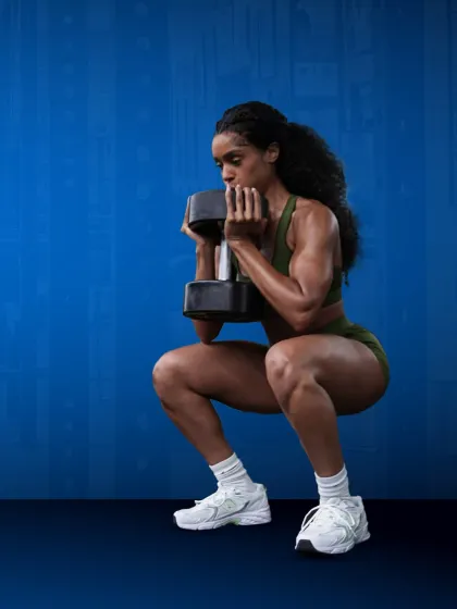Strong glutes, stronger goals. This member demonstrates perfect form in a dumbbell goblet squat, targeting the entire lower body.