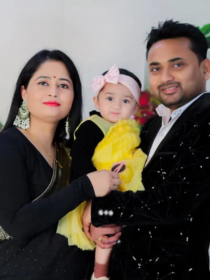 A lovely family portrait in front of our floral-themed tent setup. The bright yellow dress on the little girl adds a wonderful pop of color.