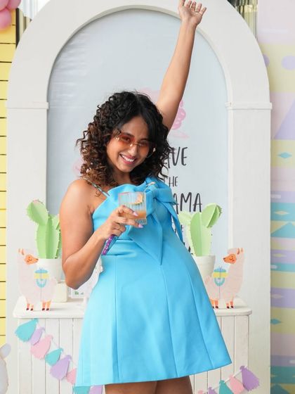 A guest enjoying the fun, vibrant atmosphere of the Llama party.