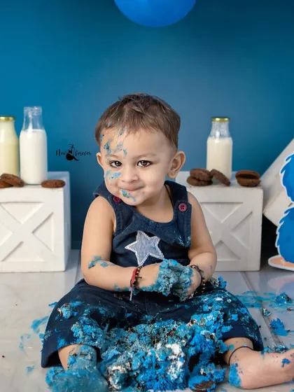A sweet, frosting-covered smile after a successful cake smash. These are the beautifully chaotic memories you'll laugh about for years to come.