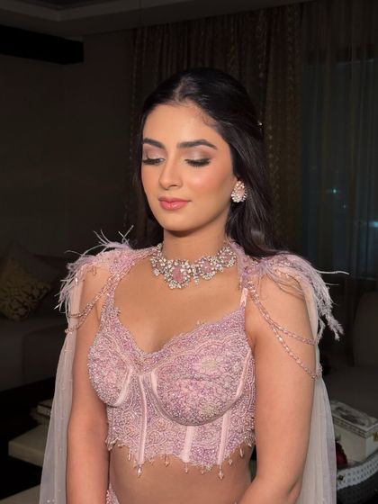 A close-up of a fresh, youthful glow with a hint of sparkle. The makeup is soft and luminous, with a focus on pink tones for an ethereal and romantic feel.