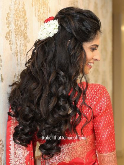 A detailed look at the soft, voluminous curls created for this engagement look. This hairstyle is perfect for brides who want to keep their hair open and flowing.