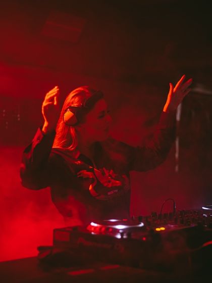 Hands up, lost in the music and red smoke. This is me at my most expressive during a high-energy techno set.