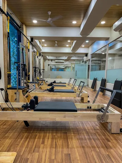 Another perspective of our studio, showing the neat arrangement of our Pilates Reformers. The clean, uncluttered space helps promote a clear and focused mind during your session.