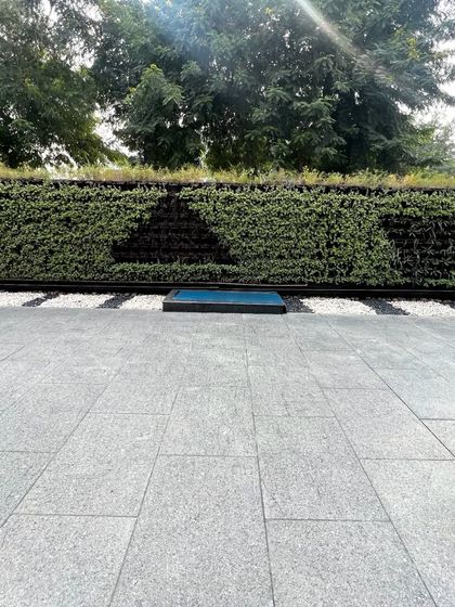 A frontal view of the patterned outdoor vertical garden, showcasing the clean lines and healthy, dense foliage. This installation is built to withstand outdoor conditions while maintaining its sophisticated aesthetic.