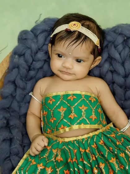 This little Radha decided to stay awake for her shoot, giving us this adorable and slightly curious look.