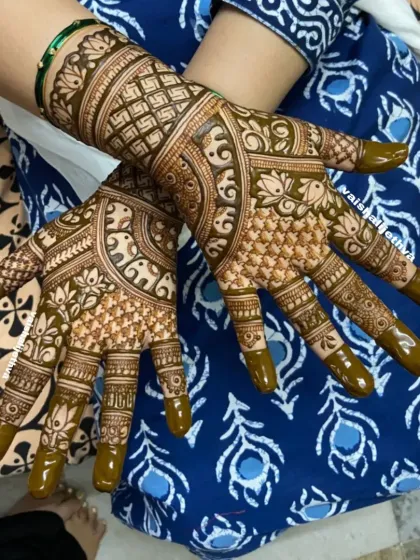 A stunning back-hand design with lotus and elephant motifs. The use of negative space makes the patterns stand out, creating a modern yet traditional feel.