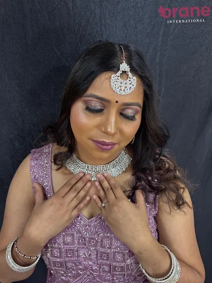 A graceful pose showcasing the diamond jewelry and soft, wavy hairstyle.
