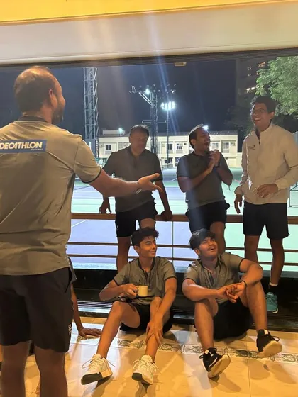 It's not just about hitting balls. Our certified coaches take the time to connect with every group, ensuring everyone feels comfortable and engaged. Here we are discussing strategy and sharing a few laughs between matches.