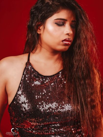 A close-up portrait with a pensive expression. The lighting is soft, creating a moody and atmospheric feel.