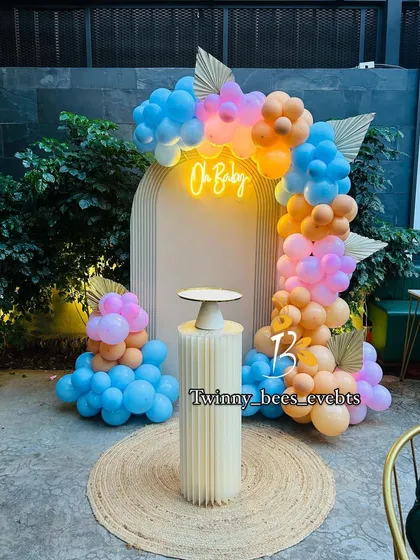 We love playing with color, and this modern "Oh Baby" setup is a great example. The combination of blue, pink, and orange balloons with a neon sign creates a fun and energetic vibe, perfect for a contemporary baby shower celebration.