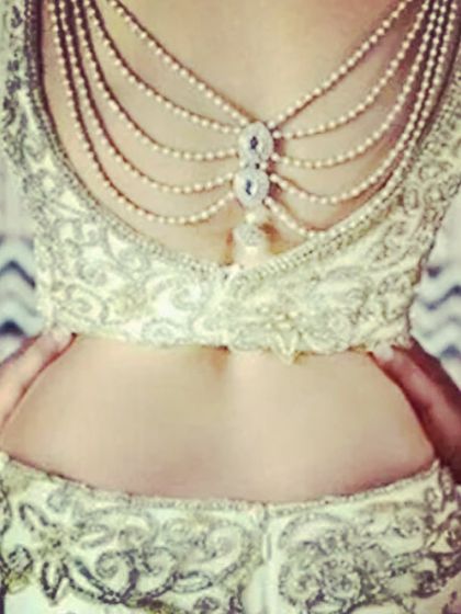 An exquisite blouse back featuring delicate pearl chains. This kind of detailed work is perfect for a bridal or reception outfit to make you stand out.