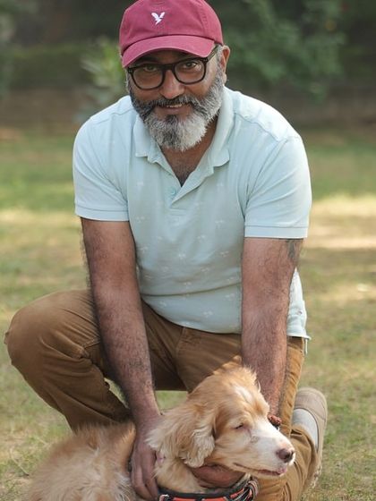 A pet parent posing with his happy dog at our party. We love seeing families enjoy our space together.