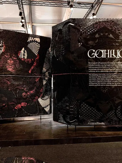 We interpreted the contemporary Goth subculture in our 'Gothilicious' installation. The piece uses large, woven black fabric panels adorned with stylized tattoo art to project a bold, sensual, and moody persona. It is an exploration of darker emotions and complex ideas through scarred surface textures and evocative finishes.