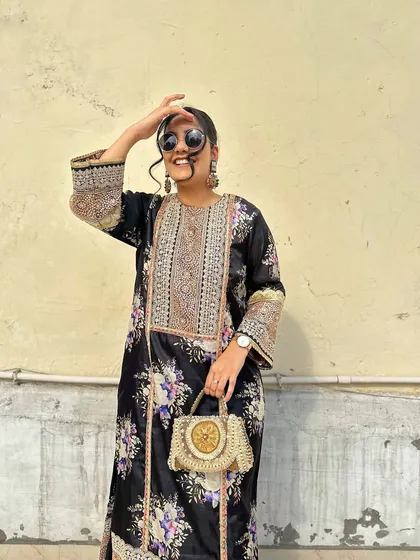 A candid moment that captures the effortless style of pairing a handcrafted accessory with a beautiful printed kurta.